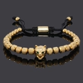 Men's gold bead bracelet featuring a leopard head center and green eye accents - Gold Wolf Head