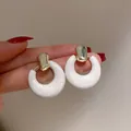 Minimalist white marble resin hoop earrings with golden studs shown in a high-quality macro view - Gold/White Ring Buckle