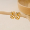 Macro detail of triple heart gold earrings with pavé white cubic zirconia inlay - EH411013