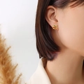 Minimalist 18K gold-plated square stud earrings featuring a cherry pattern on model - Steel
