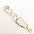 Macro detail of handbag strap with hot air balloon pattern and Flower embroidery - Hot Air Balloon + White Leather
