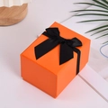Orange rectangular gift box featuring a black ribbon bow and textured surface - 10*7.5*7cm / Orange with Black Bow