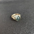 Detail of handmade gold wire-wrapped ring featuring a sphere green moss agate stone - Adjustable Open / India Agate