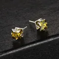 Macro shot of square-cut green zircon earrings with four-claw silver setting detail - Green Pair