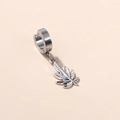 Detailed view of silver leaf pendant earring in punk style on clean pastel backdrop - Leaf