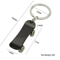 Mini skateboard keychain in black metal finish with detailed size measurements and net weight - X-1198 Skateboard / Black