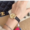 Elegant gold diamond-encrusted ladies watch with a black leather strap on a model wrist - Gold Dial Black Leather Strap