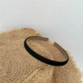 Detail of a minimalist black fabric headband placed on a straw hat for styling - Black