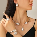 Detailed view of Baroque pearl jewelry set including necklace, bracelet and ring on model - Silver Baroque Pearl 5-Piece Complete Set