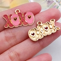 Handheld view of XOXO heart charms in pink oil drip and hollow gold metal finish - Red XOXO Letter Plate (21198)
