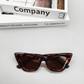 Detail of retro cat-eye sunglasses with tortoise shell frame and dark brown lenses - Leopard Print