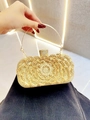 Detail of evening clutch featuring golden floral rhinestone patterns and round handle - Gold