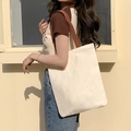 Canvas tote bag in beige with brown shoulder straps shown on a model for daily use - Blank Bag