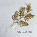 Detailed view of a 42cm golden artificial glitter fern branch for festive decoration - 5-Prong Large Persian Leaf