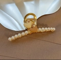 Close-up of golden metal hair claw clip with elegant pearls and layered heart charms - Heart Shaped Pearl Hair Claw