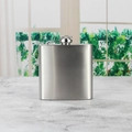 Classic silver stainless steel flask with a 6oz 8oz capacity and screw cap on a grey surface - Natural