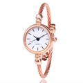 Macro view of rose gold rope bangle watch with a minimalist white dial and quartz movement - Rose Gold White Dial Linear Scales