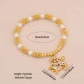 Pulsera elástica dorada con perlas blancas y un colgante de tortuga marina con cristales - Tortuga marina