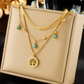 Gold multi-layer necklace with Tree of Life pendant and turquoise stones on display stand - Tree of Life Turquoise Triple-layer Style (N2268)