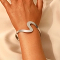 Minimalist silver wavy open cuff bracelet with polished finish on model wrist - Silver Wavy Curved Open Bangle (10581)