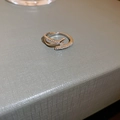 Detailed macro view of silver crossover ring featuring micro-pave cubic zirconia stones - Crossed