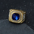 Macro shot of gold men's ring with large blue gemstone and white zircon pavé on black rock - US 7 / Gold Blue Stone