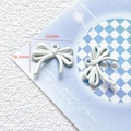 Macro shot of white matte bow pendant with 22mm by 18.5mm size dimensions shown - 33# Matte White Bow