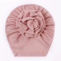 Close-up of pink ribbed baby turban hat featuring a 3D knit rosette floral detail - Pink