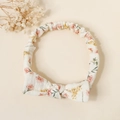 Detail of floral baby headband with a cute bow on textured cotton cream fabric - Pink Floral