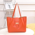 Vibrant orange textured leather tote bag with gold metal buckle and dual shoulder straps - Orange Red