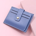 Detail of blue faux leather card holder with litchi grain and metallic snap button - Blue