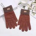 Close-up of caramel knit gloves with gray ribbed cuffs and a leather logo brand patch - Rose Gold