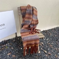 Detail of thick caramel plaid scarf with long fringes draped on a wooden chair - Striped Maple Red