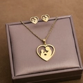 Detail of gold heart necklace and studs with mother-child silhouette in jewelry gift box - Mother Child Heart