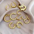 Detail view of 12-piece gold hoop earring set with smooth and twisted C-shape designs - 37# Silver Pin (12-Piece Set) / Gold