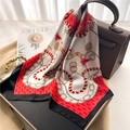 Detail of red and white printed silk scarf with golden chain patterns on a leather handbag - Black Border Red