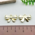 Golden hollow bowknot charms for DIY jewelry making, 2cm size shown with scale ruler - Mini Bowknot - KC Gold (21384)