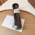 Close-up of black elastic hair ties in a clear cylindrical jar with a black lid - 100 Pcs Mixed Color Set (Style One)