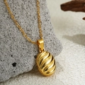 Elegant 18K gold textured oval locket necklace on a rustic grey stone background - Oval Stripe