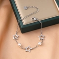 Star and pearl stainless steel bracelet featuring silver pentagram charms on a green box - Silver