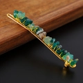 Detailed macro shot of natural green crystal stones on a gold wire-wrapped hair clip - Green Agate + Gold Clip