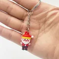 Detailed view of a 3D mini Santa Claus keychain made of soft PVC with a silver keyring - Santa Claus Style D