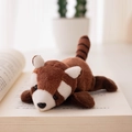 Brown and white plush red panda slap bracelet toy resting on an open book - Refrigerator Magnet / Brown