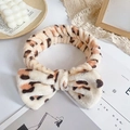 Plush beige leopard print headband with a large bow for skincare and makeup routines - Coffee Leopard