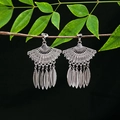 Detailed view of silver ethnic fan-shaped fringe earrings hanging on a natural branch - E4990-6 (Rhombus Hollow)