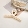 Matte cream large shark hair claw clip shown in a minimalist aesthetic setting - Cross / Off-white