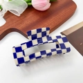 Acetate hair claw clip featuring a classic blue and white checkerboard pattern on a wooden tray - 10.5cm / Navy Blue