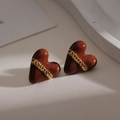 Luxury dark brown heart stud earrings with gold chain detail and polished finish - Caramel color