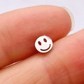 Polished silver stainless steel smiley face stud earring held between fingers - Silver Smiley