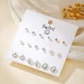 Detailed set of geometric heart and pearl stud earrings arranged on a white display card - Gold Silver Mixed Pearl Leaf Earrings (E1937-1)